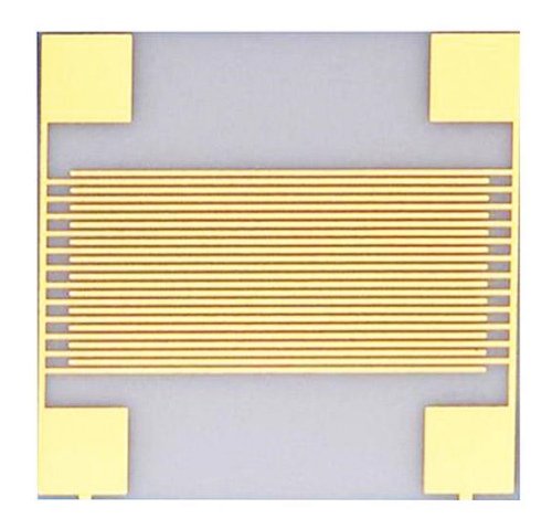 Ceramic sample carrying closely spaced parallel gold-colored conductor lines